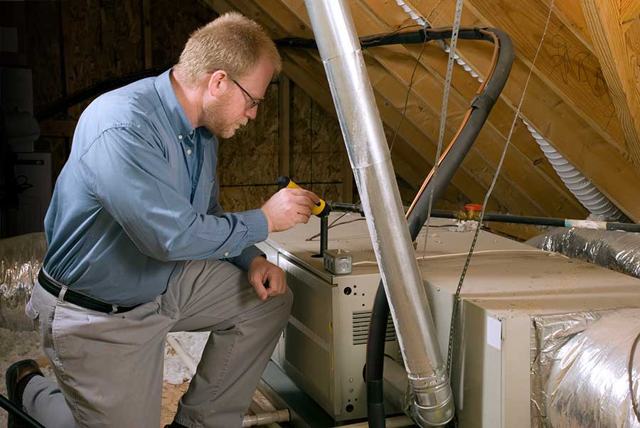 service tech inspecting a furnace